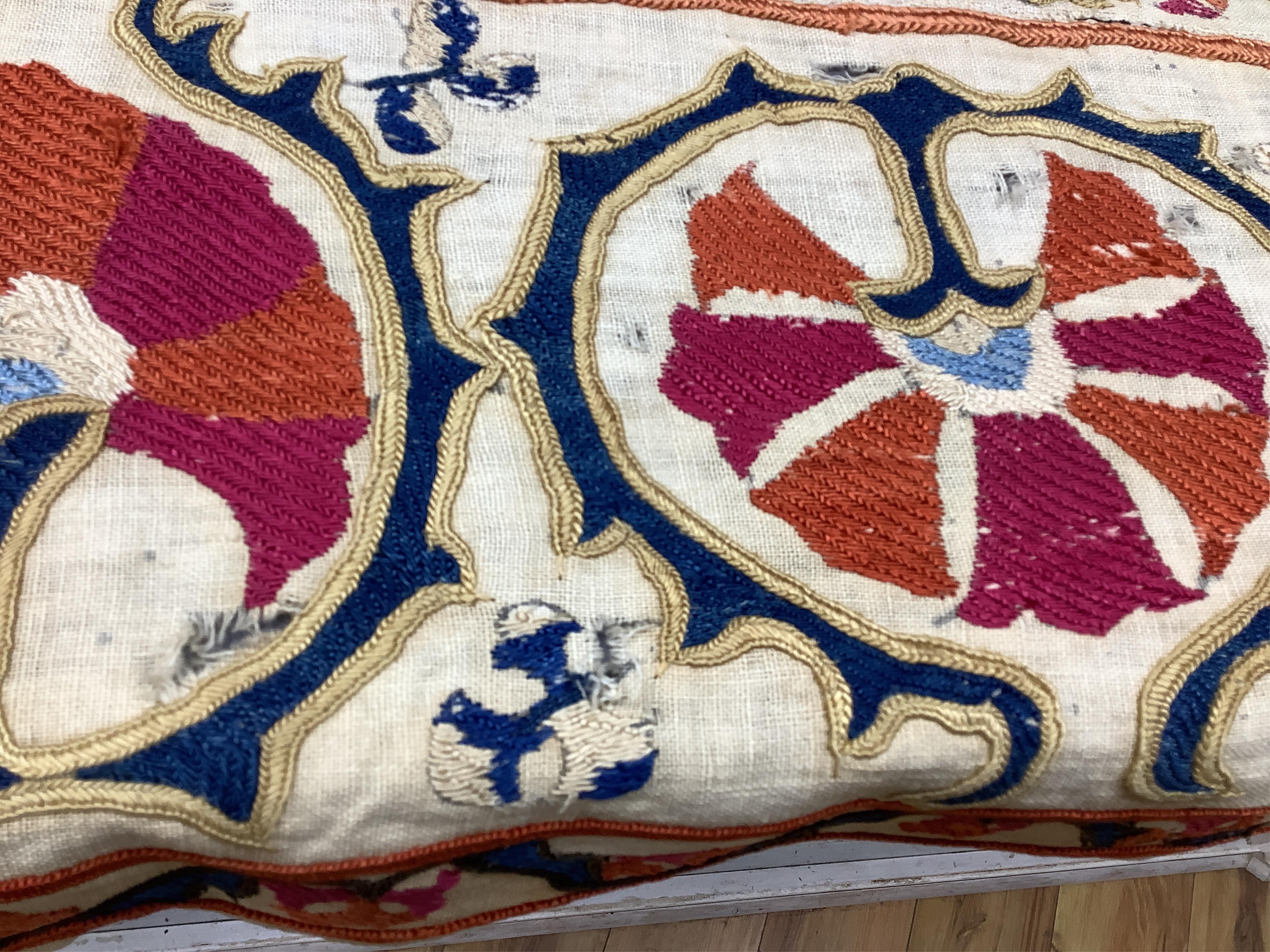 A 19th century Uzbekistan Suzani, hand embroidered hanging. Made from hand woven linen panels each approximately 28cm wide x 167cm long. Hand embroidered with silk hand dyed threads, in orange, red, blue and yellows, usi